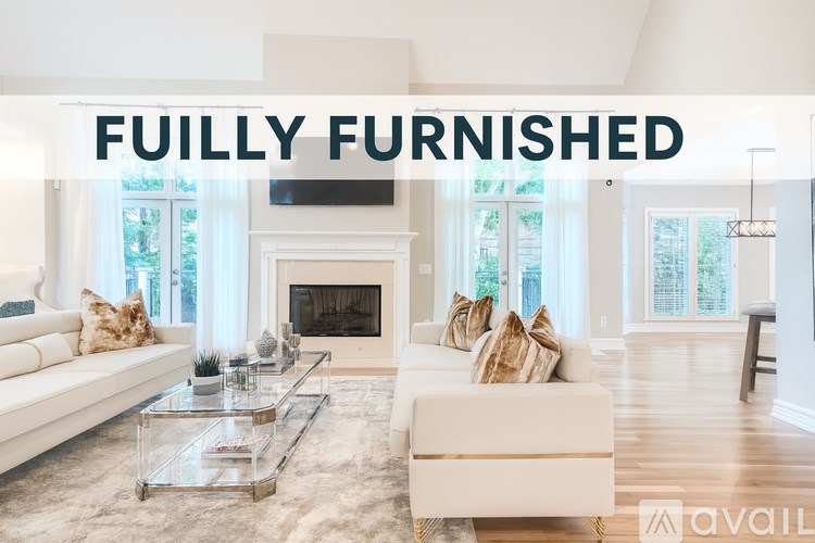 A modern living room with a fireplace and a glass coffee table.