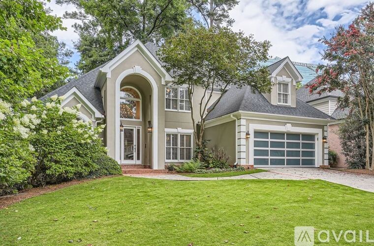 A house with a large front yard and a garage.
