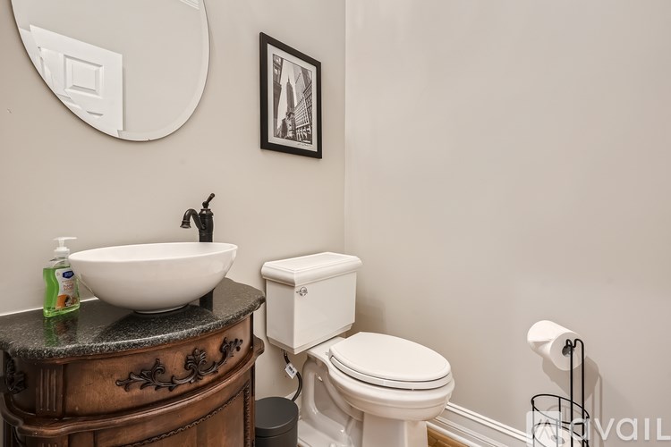 A white toilet sits next to a sink in a bathroom.