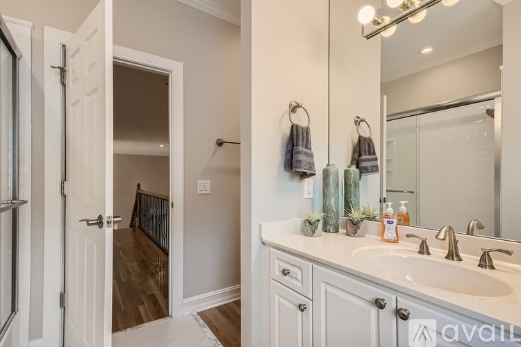 A bathroom with a white sink and a mirror.