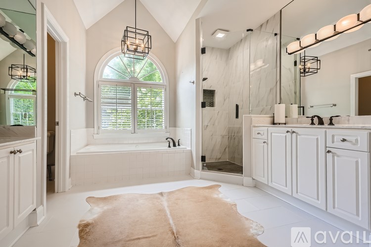 A bathroom with a cowhide rug in the middle of the floor.