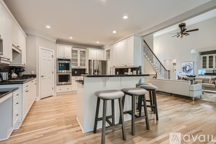 A modern kitchen with white cabinets and a central island.