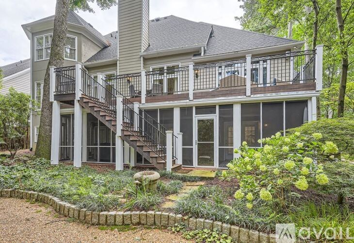 A large house with a balcony and a staircase.