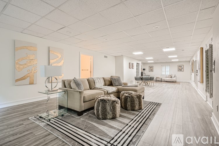 A spacious living room with a large sectional sofa and a glass coffee table.