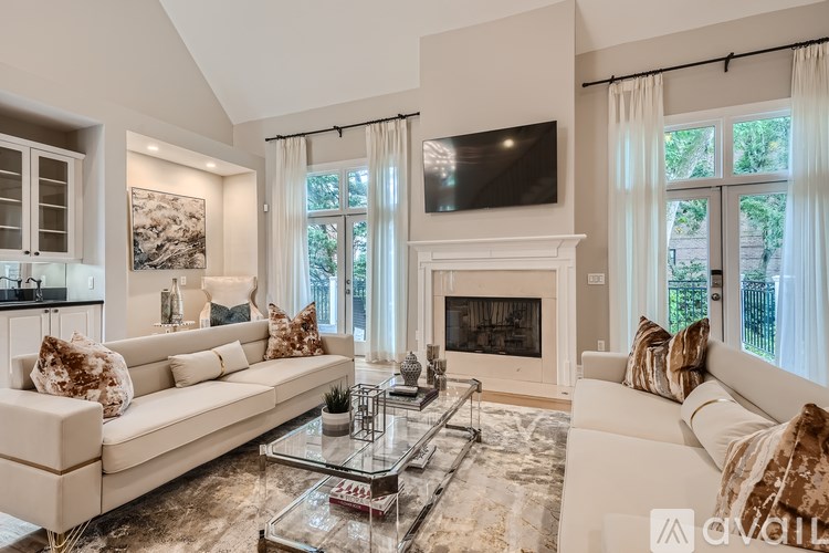 A living room with a fireplace and a television mounted on the wall.