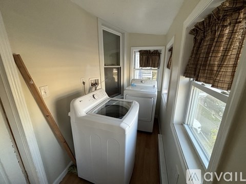 A small laundry room with a washer and dryer.
