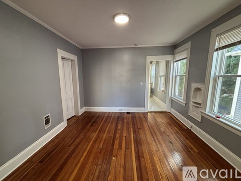 A room with wooden floors and grey walls.