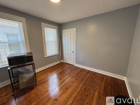 A room with wooden floors and a white door.