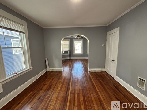 A room with wooden floors and a white door.