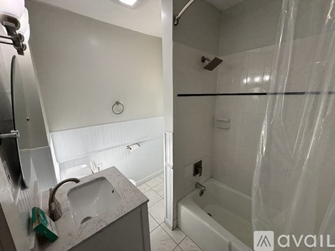 A bathroom with a sink and a shower.