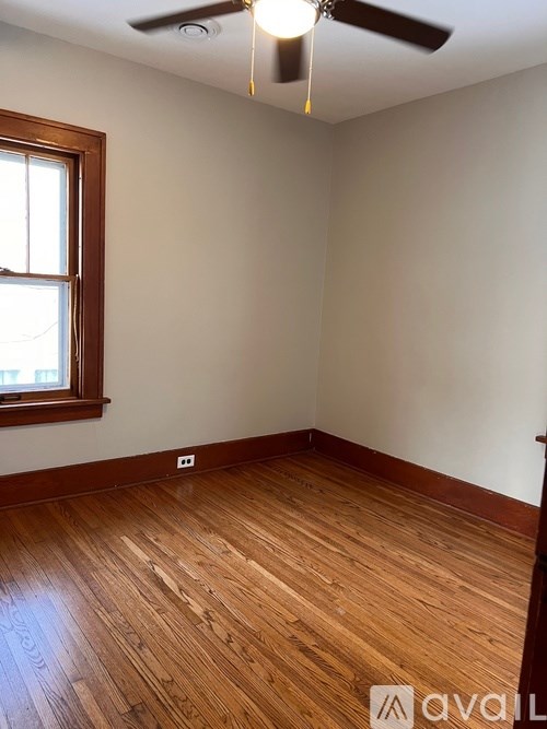 A room with wooden floors and a window.