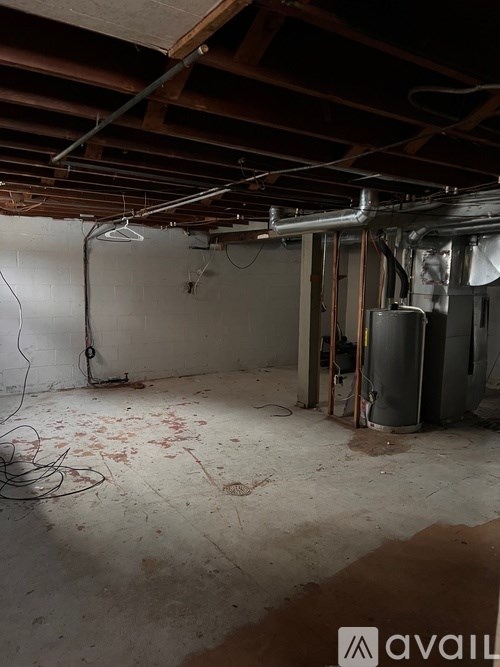 A room with a lot of pipes and a dirty floor.