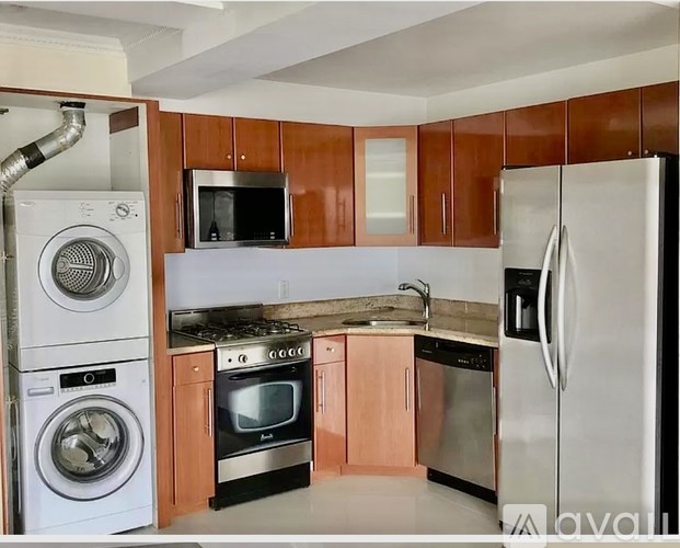 A kitchen with wooden cabinets and a white refrigerator.