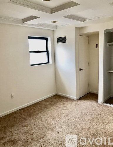 A room with a window and a door.