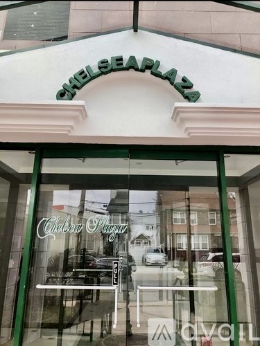 A storefront with a green awning and a glass door.