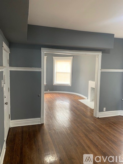 A room with wooden floors and a window.