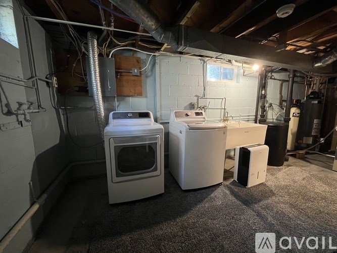 A room with a wood stove, a white oven, and a white fridge with a window.