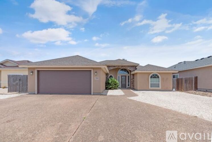 A house with a driveway and garage is available for sale.