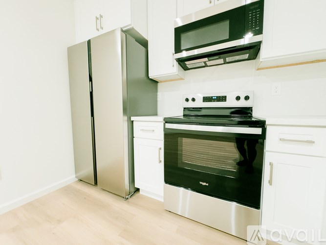 A kitchen with a stove, oven, and refrigerator.