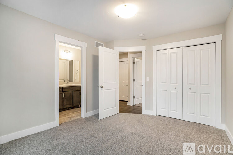 A room with white doors and a carpeted floor.