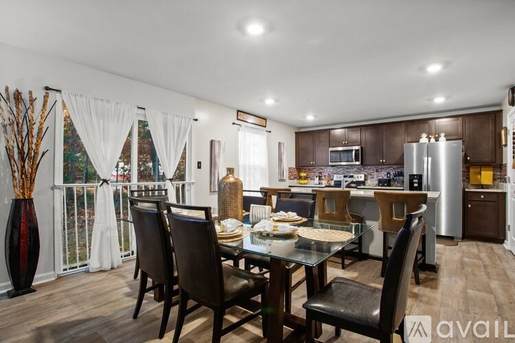 A modern kitchen with a dining table set for four.