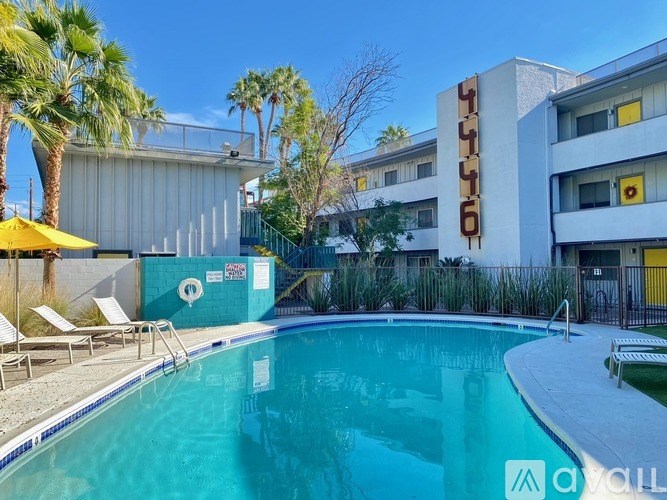 A pool in front of a building with the name "CYLUS" on it.