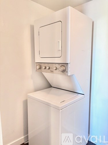 A white oven and dishwasher combo unit in a kitchen.