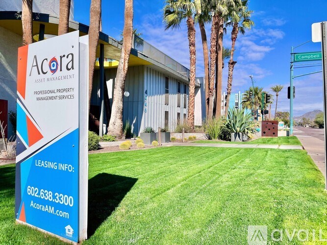 A sign for Acora Asset Management is in front of a building.