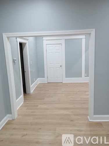 A hallway with a door on the right and a door on the left.