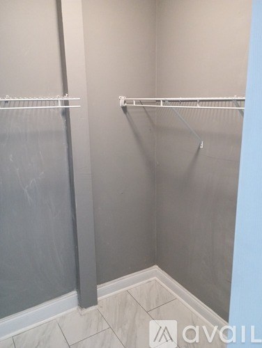 A bathroom with a walk in shower and a towel bar.