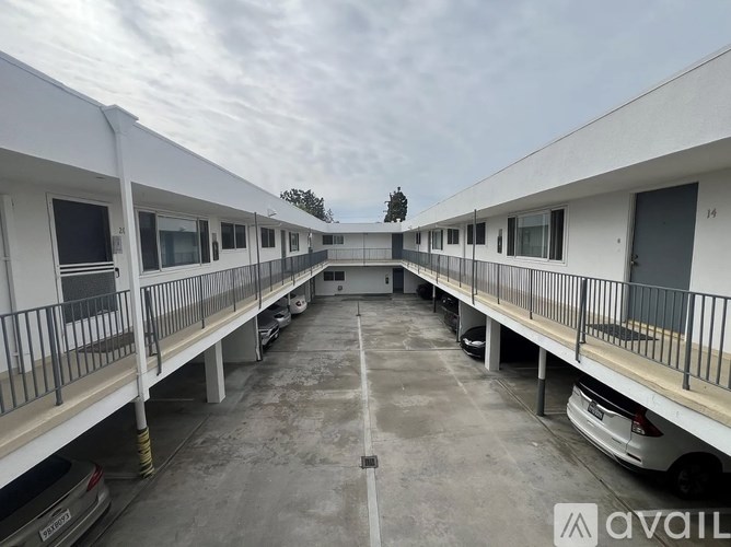 A parking garage with multiple cars parked.