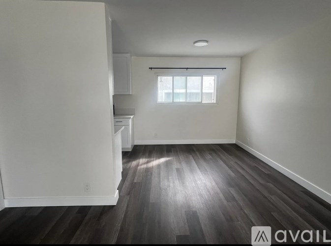 A room with wooden floors and a window.