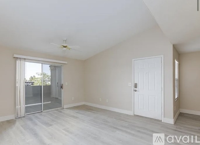 A spacious room with a sliding glass door leading outside.