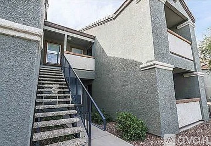 A concrete building with a staircase leading to the second floor.
