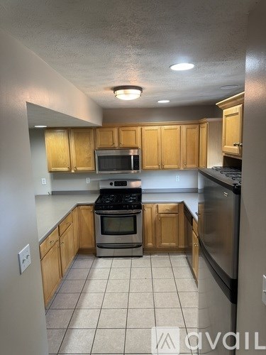 A kitchen with wooden cabinets and stainless steel appliances.