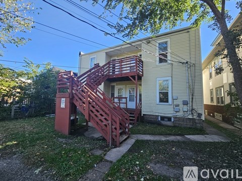 A house with a red staircase in front of it.