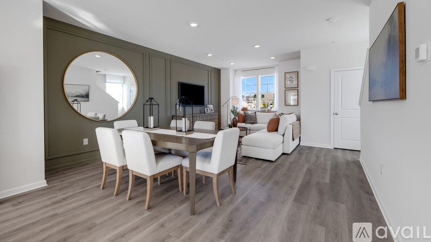 A modern dining room with a large table and chairs.