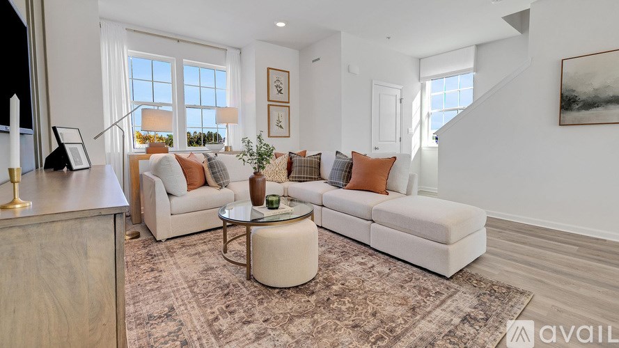 A living room with a white couch and a coffee table.