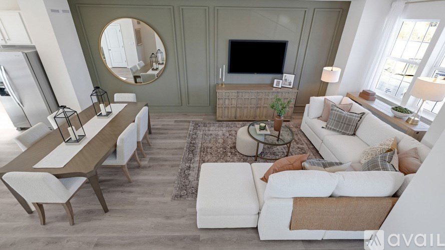 A modern living room with a white sofa and a wooden dining table.