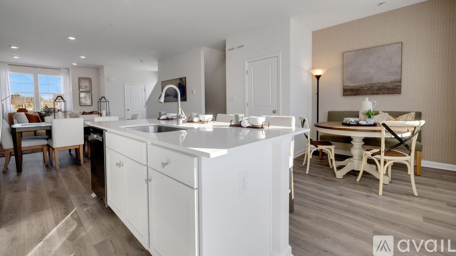 A modern kitchen with white cabinets and a large island.