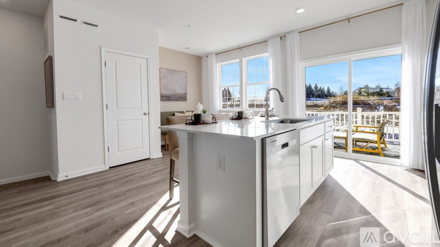 A modern kitchen with a large island and a view of the lake.