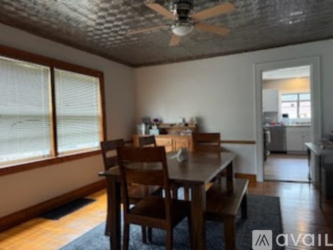 A dining room with a table and chairs.