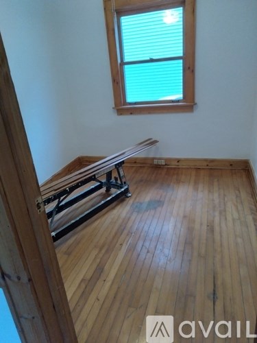 A room with wooden floors and a window.