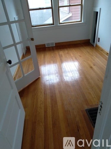 A room with wooden floors and a white door.