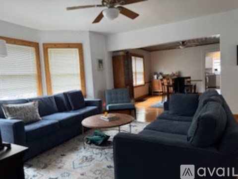 A living room with a dark blue couch and a wooden coffee table.