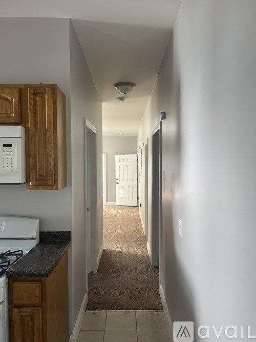 A long hallway with a door at the end.