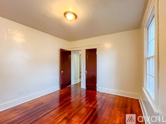 A room with wooden floors and white walls.