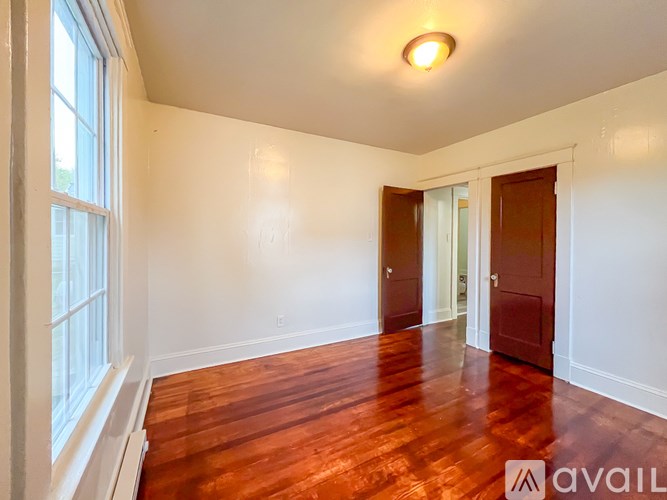 A room with wooden floors and white walls.