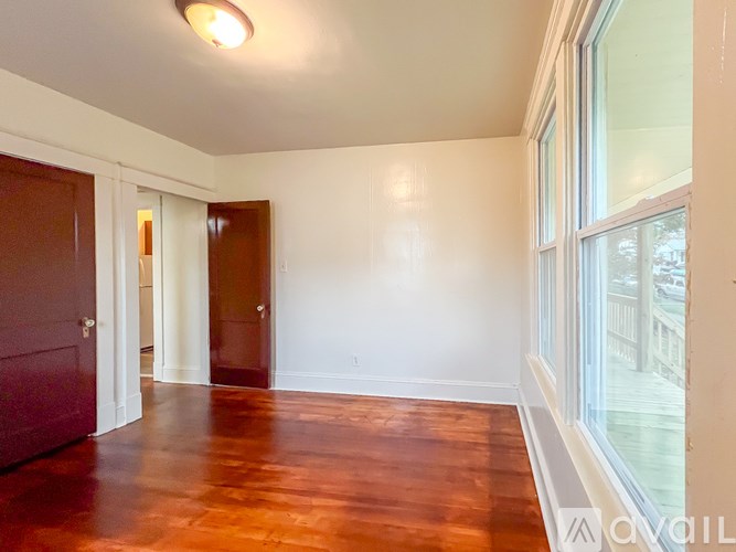 A room with wooden floors and white walls.