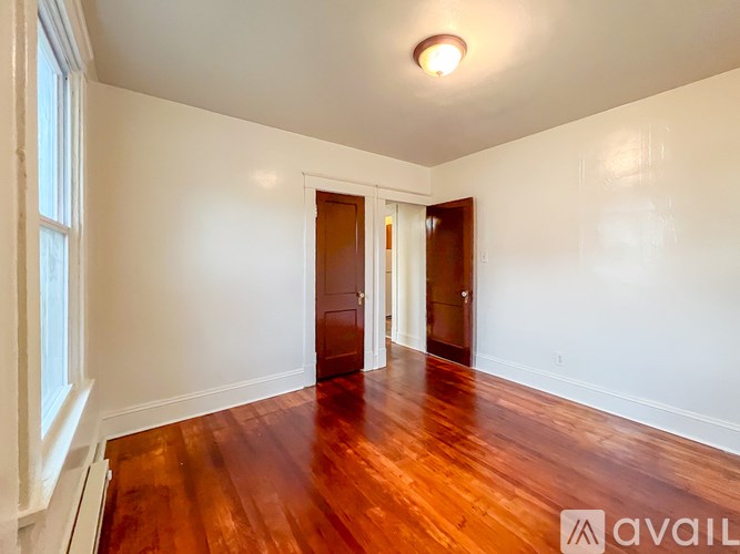 A room with wooden floors and white walls.